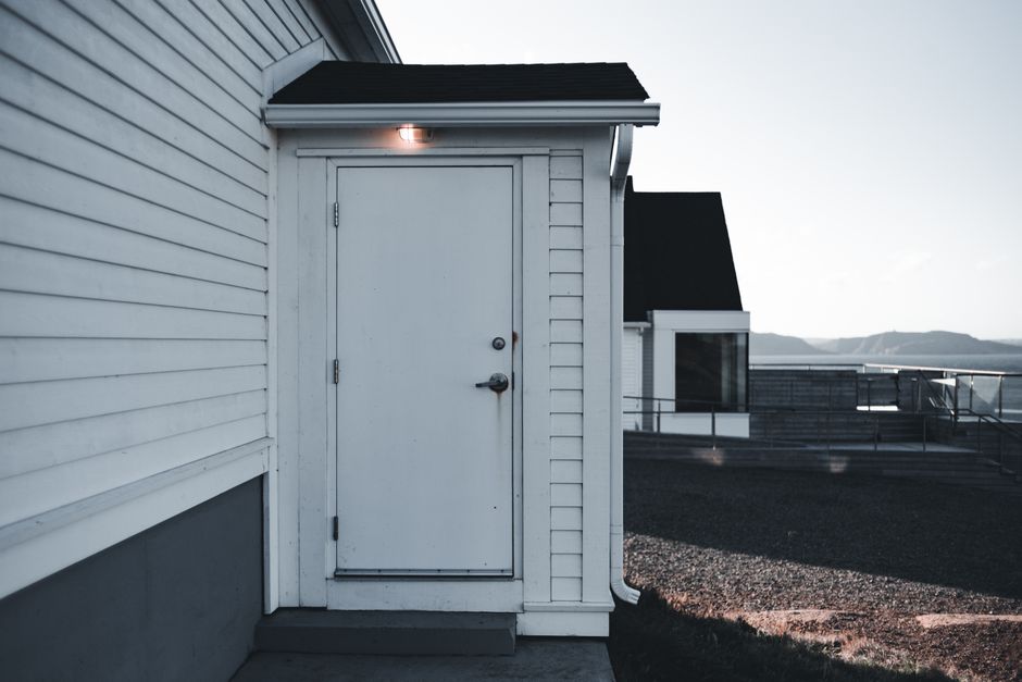 Two-story residential home exterior with freshly painted siding and trim